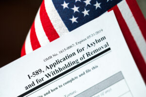 application for asylum to usa concept with application form and usa flag
